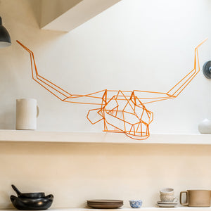 Bend Goods has a variety of animal decor pieces. Seen here is a Long Horn neatly displayed in a kitchen on a shelf. Its decor made to be wall art or home decor.