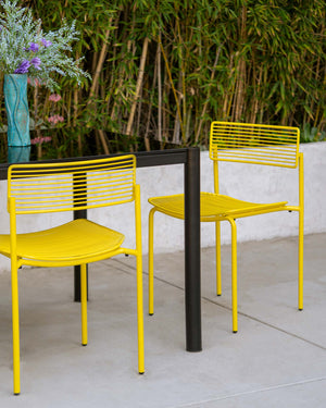 Outdoor and Indoor Dining Chair designs made from wire. Displayed here is a set of Rachel Chairs on a patio. Bend Goods side chairs are a modern design. 